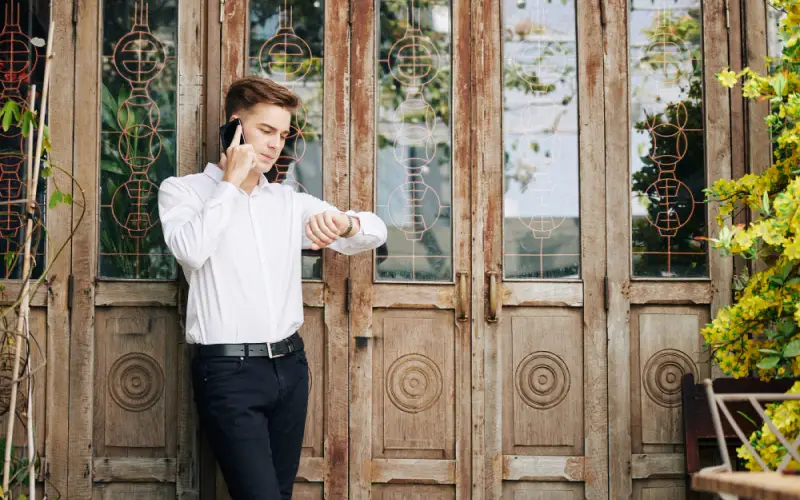 Locked Out of Your House,A man in a white shirt having a conversation on his cell phone