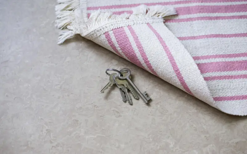 Locked Out of Your House,Pink and white striped towel with keys hidden underneath